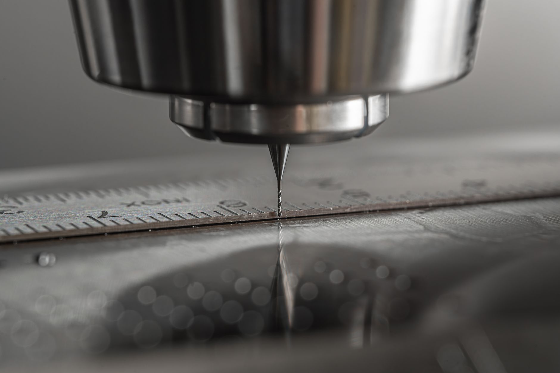 Close view of a CNC milling machine cutting a metal component with fine detail